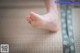 A person with a red nail polish on their toes.