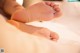 A close up of a person's feet on a bed.