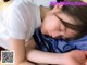 A young girl laying on the floor with her eyes closed.